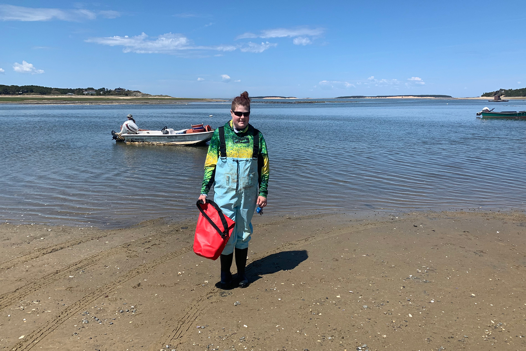 Kyra Brimdyr stands on the beach working a school project