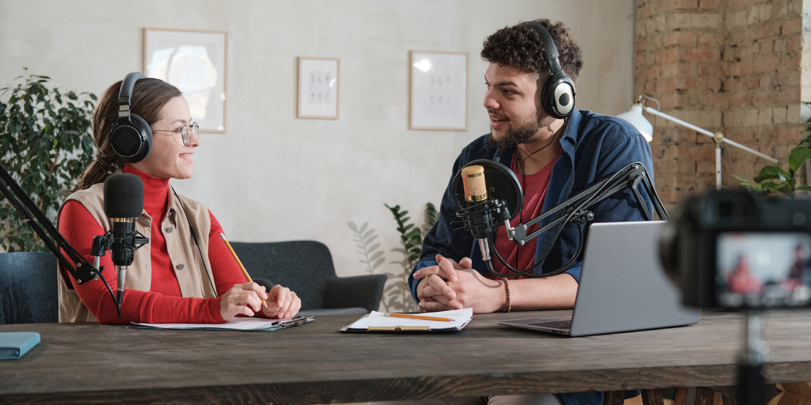 Communication_Podcast Man interviewing woman on camera for a podcast