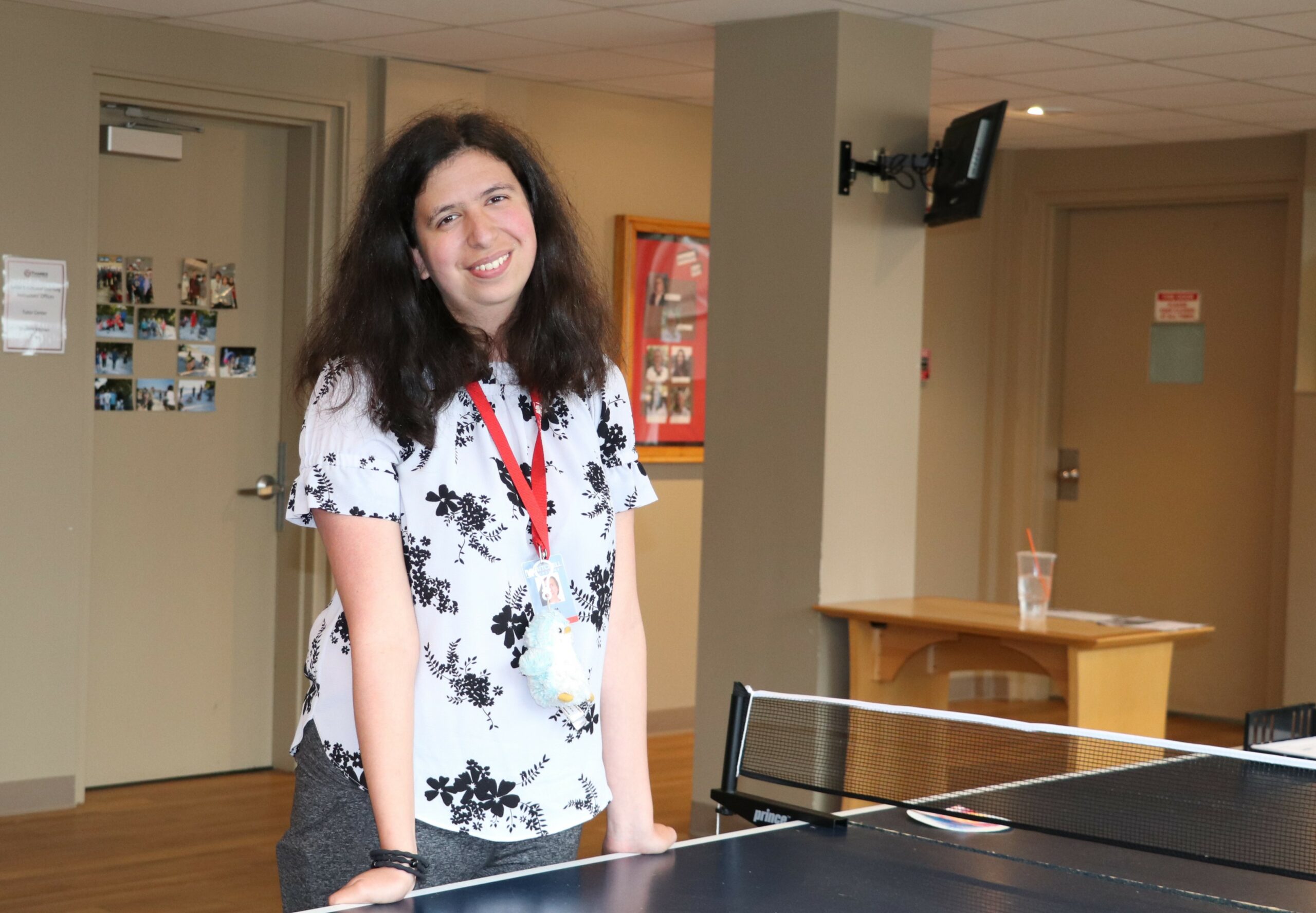 Hana Rihani poses for a picture at a ping-pong table in her residence hall.